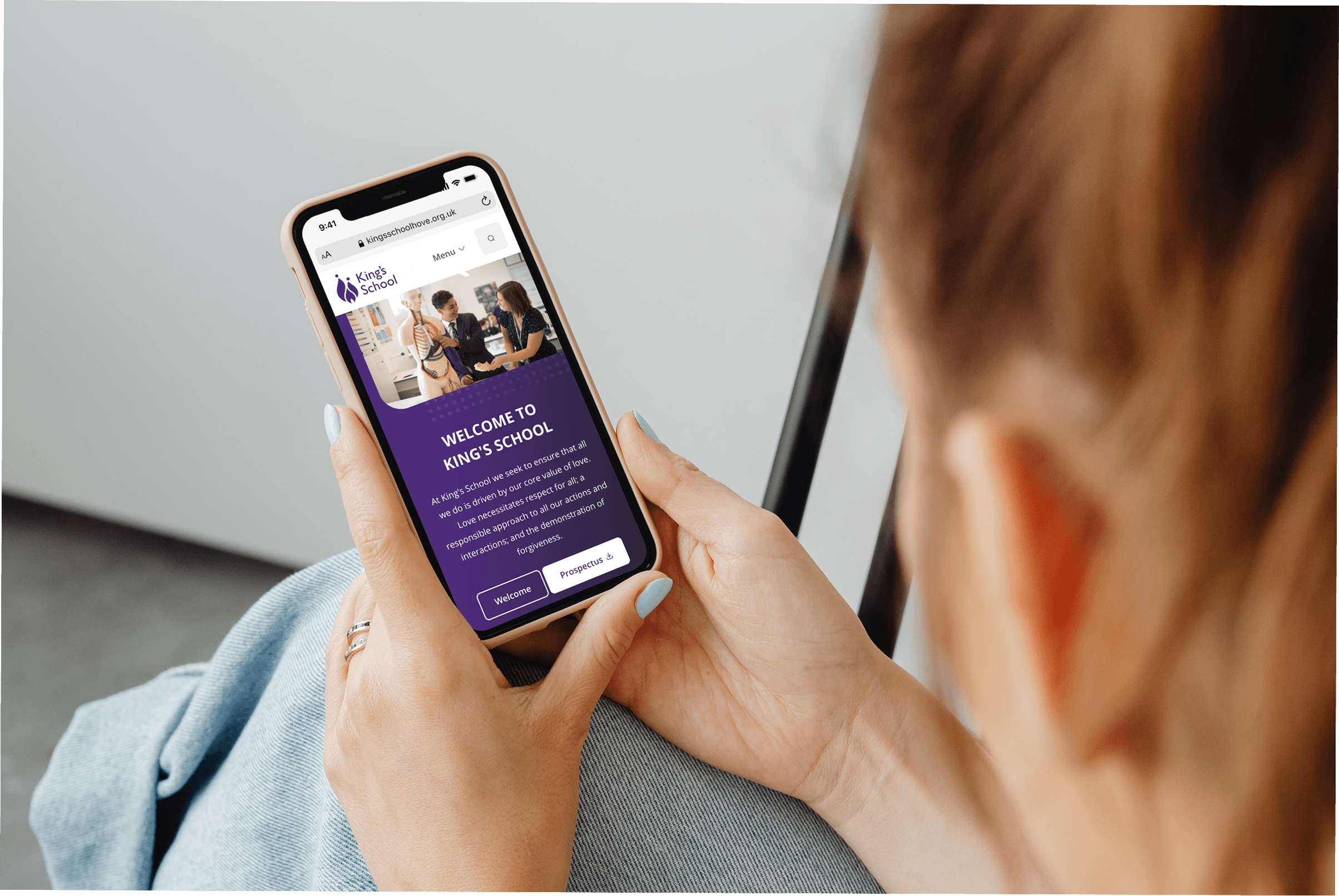 Woman browsing a school website on her phone